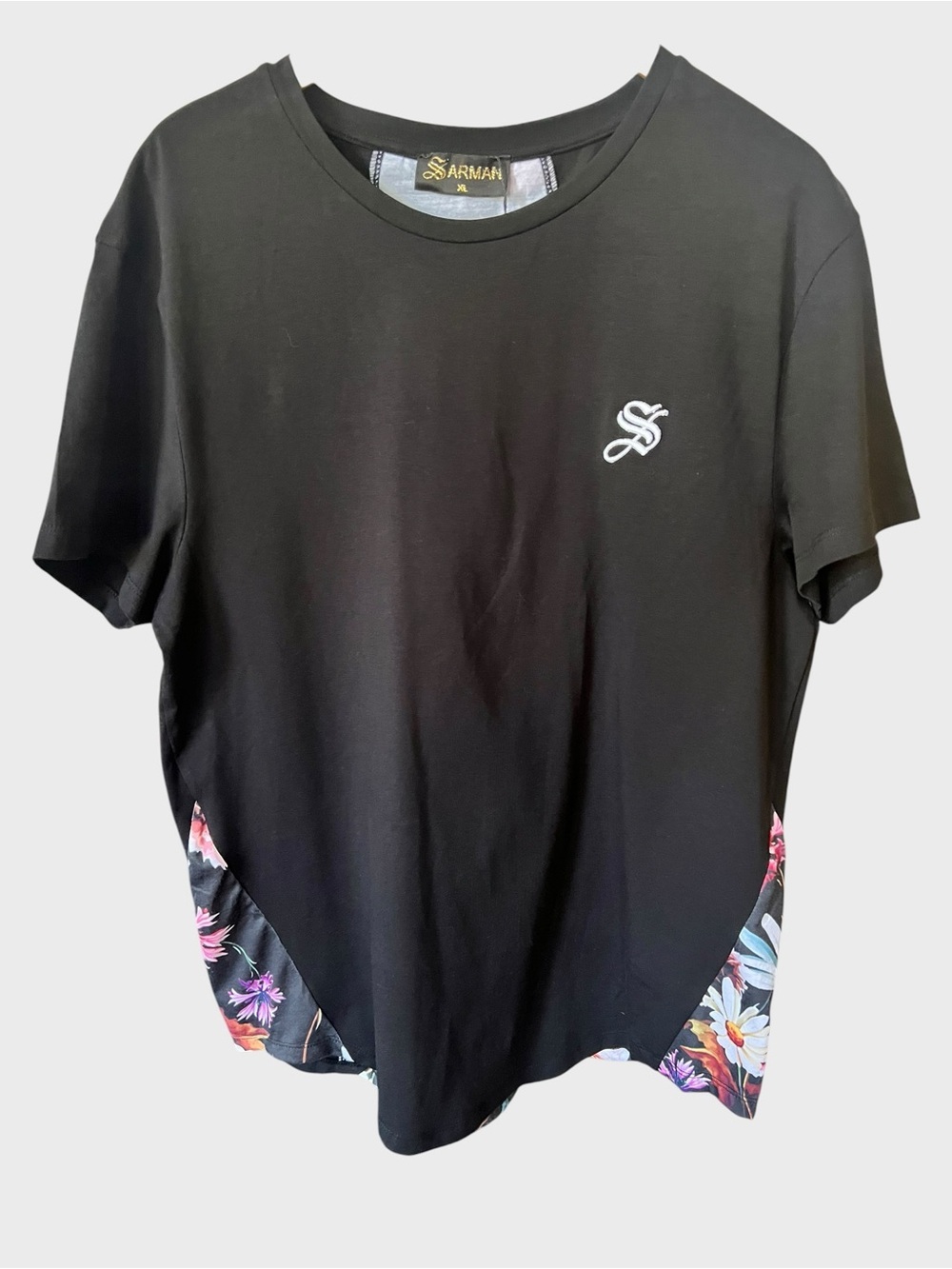Sarman women’s Black Tee with Floral Hem Accent. New with tag.